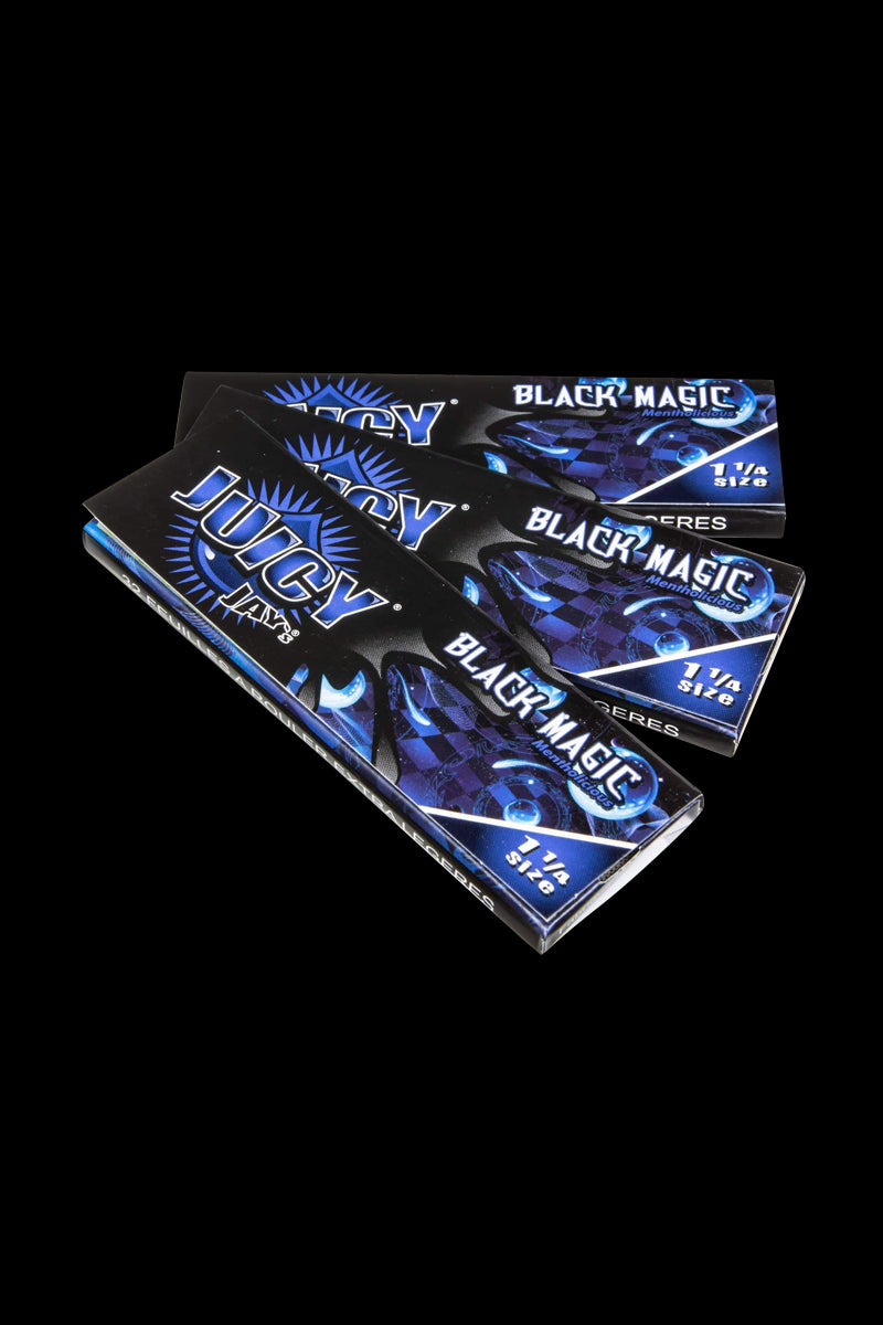 Classic 1-1/4" Size Flavored Rolling Papers are displayed in a close-up, vibrant product shot with a colorful, patterned background.