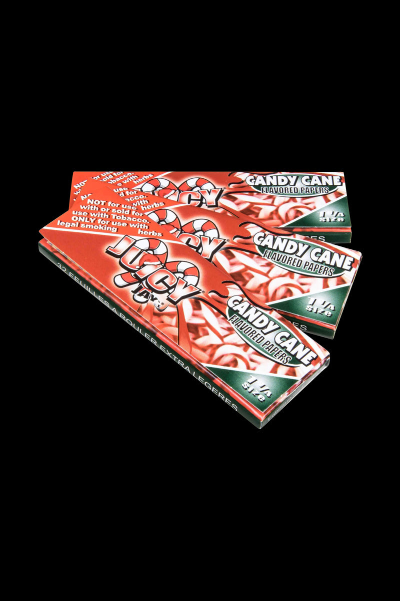 Close-up of Classic 1-1/4" Size Flavored Rolling Papers, showcasing colorful branding and stacked booklets against a dark background.