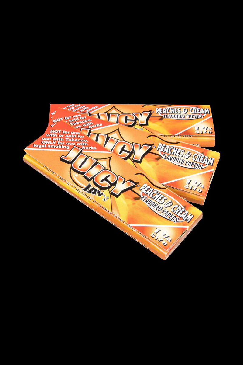 A stack of Classic 1-1/4" Size Flavored Rolling Papers is shown in a brightly lit, angled close-up.