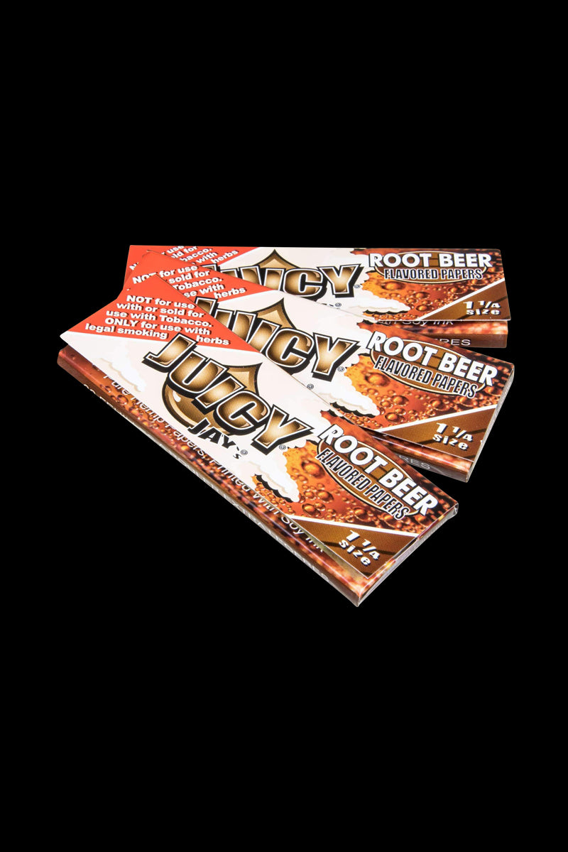 A close-up, angled view of Classic 1-1/4" Size Flavored Rolling Papers with a bold, colorful design against a dark background.