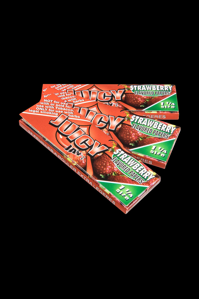 A close-up of a package of Juicy Jay's Classic Size Flavored Rolling Papers against a black background.