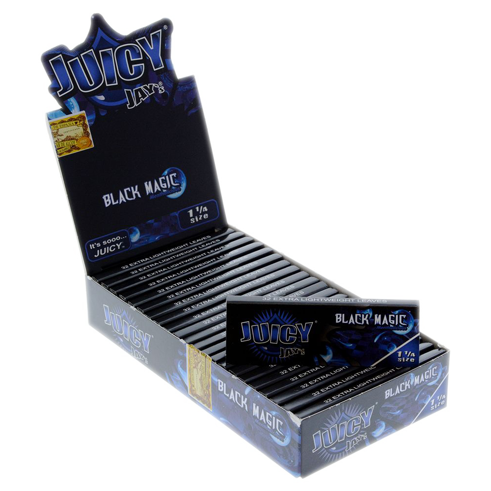 A close-up of Juicy Jay's 1 1/4 Black Magic Rolling Papers packaging, with the black pack angled slightly toward the viewer.
