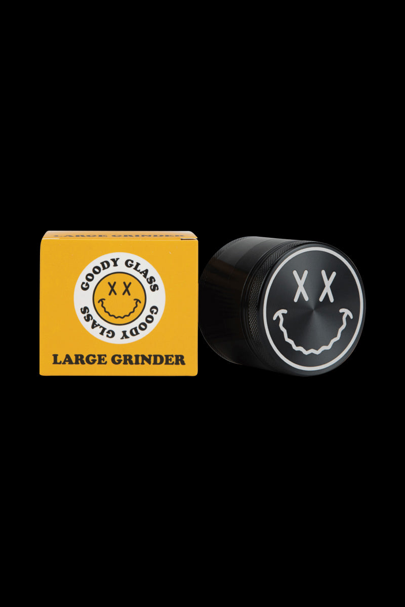 A close-up of the Goody Big Face Travel Size Grinder, showing its circular design against a plain black background.