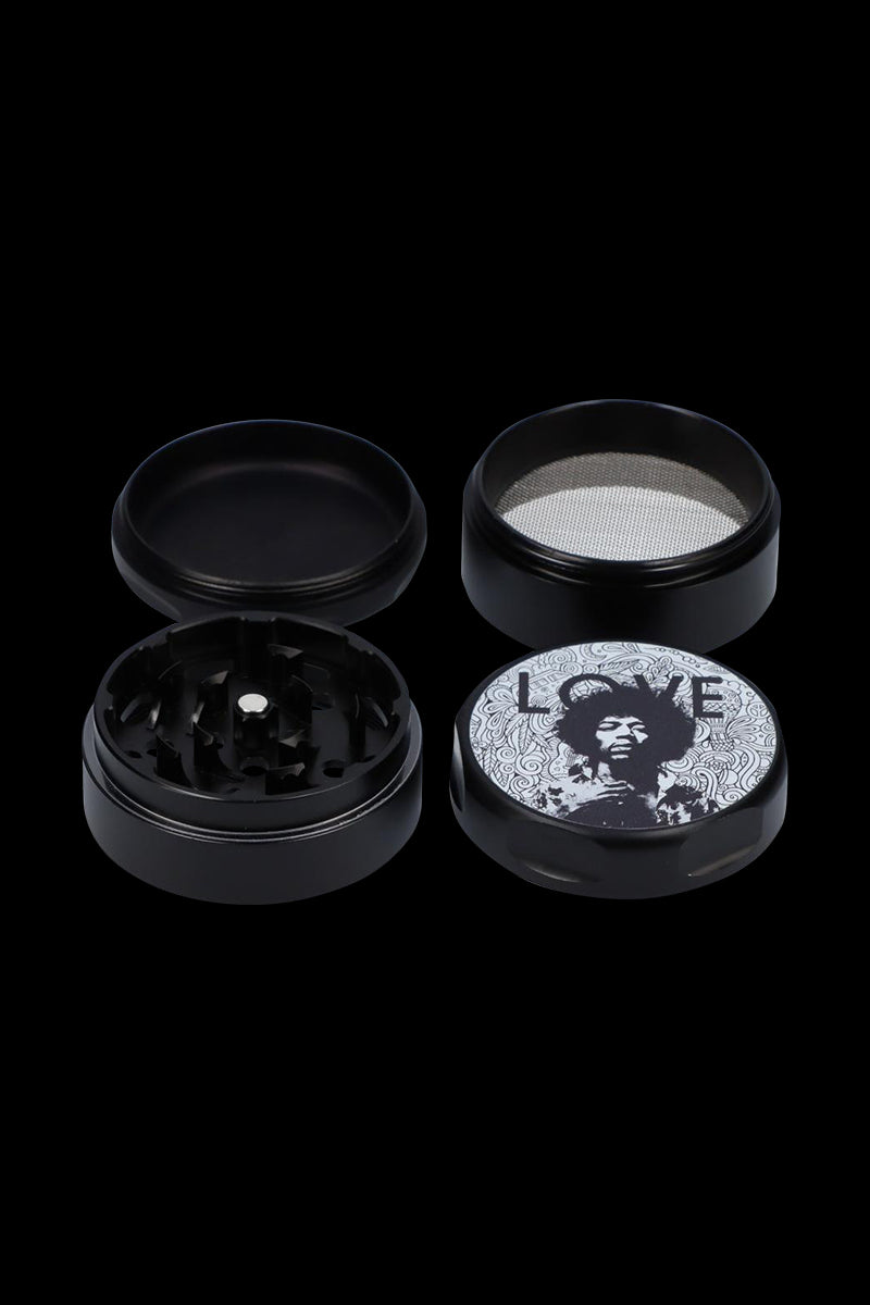 Top-down view of the Rock Legends "Jimi Love" Grinder opened to show its black anodized four-piece sections and a lid featuring a black-and-white Jimi Hendrix portrait with "LOVE" text.