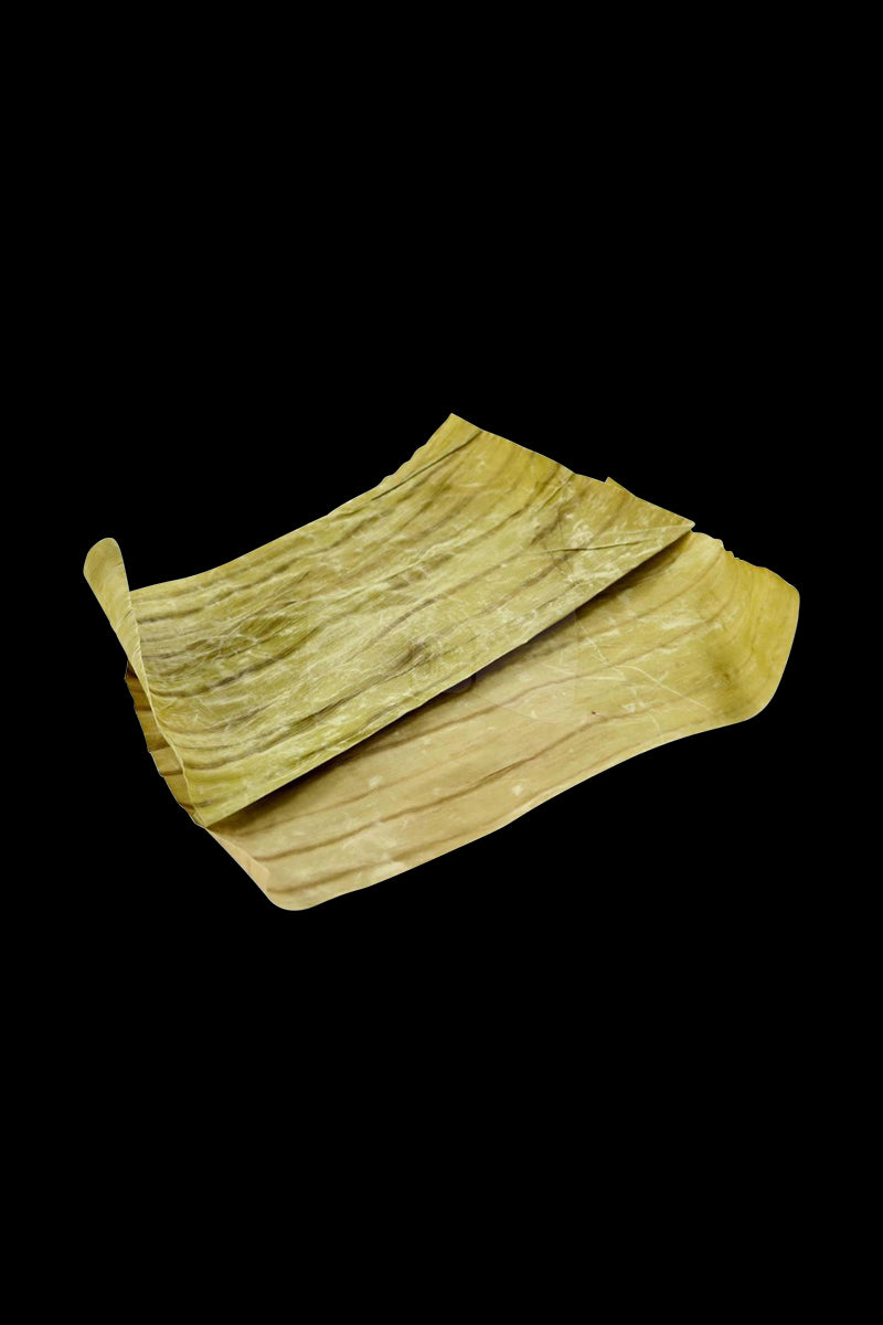 A close-up view of the Million Bananas Pouch Cured Rolling Leaf, showing a folded, textured leaf against a dark background.