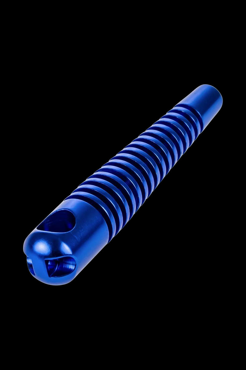 Angled close-up of a metallic blue Skeleton Hand Pipe with ribbed grip and skull-shaped bowl against a black background