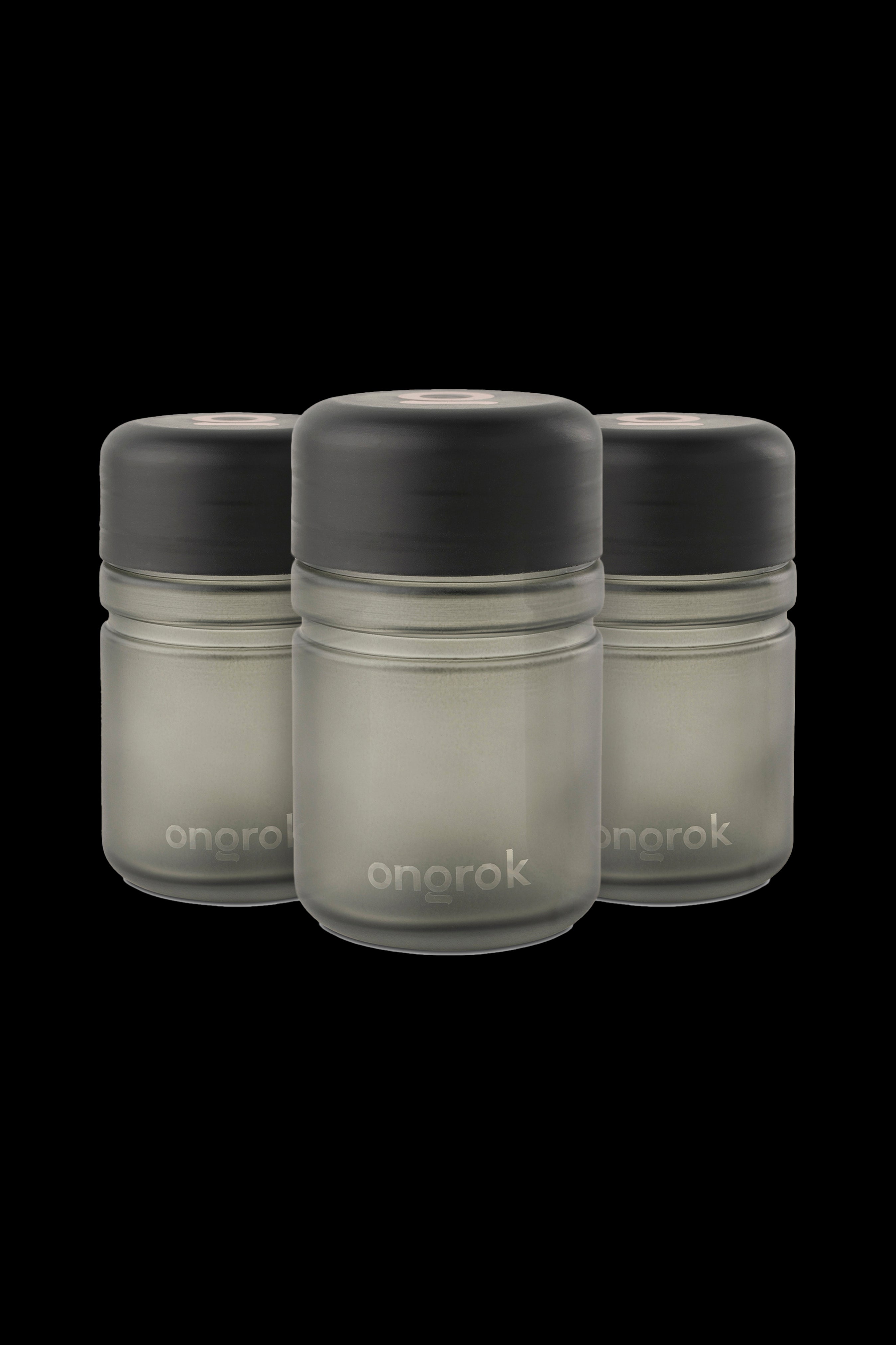 Three Onrok cannabis oil vape cartridges with black caps and frosted glass bodies against a black background.