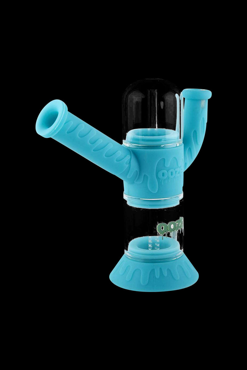 A studio shot features the Ooze "Cranium" Silicone 4-in-1 Glass Water Pipe, showcasing its curved neck and clear glass construction.