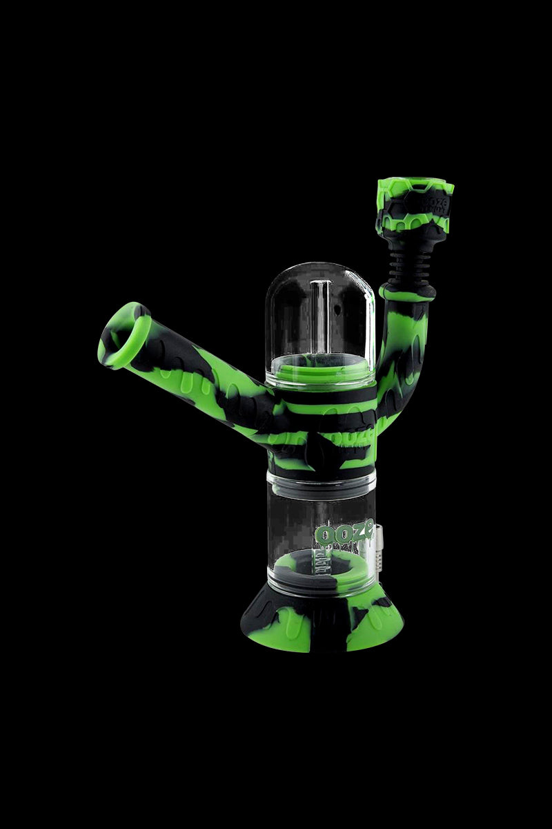 A studio shot of the Ooze "Cranium" Silicone 4-in-1 Glass Water Pipe, showcasing its colorful silicone accents and clear glass construction.
