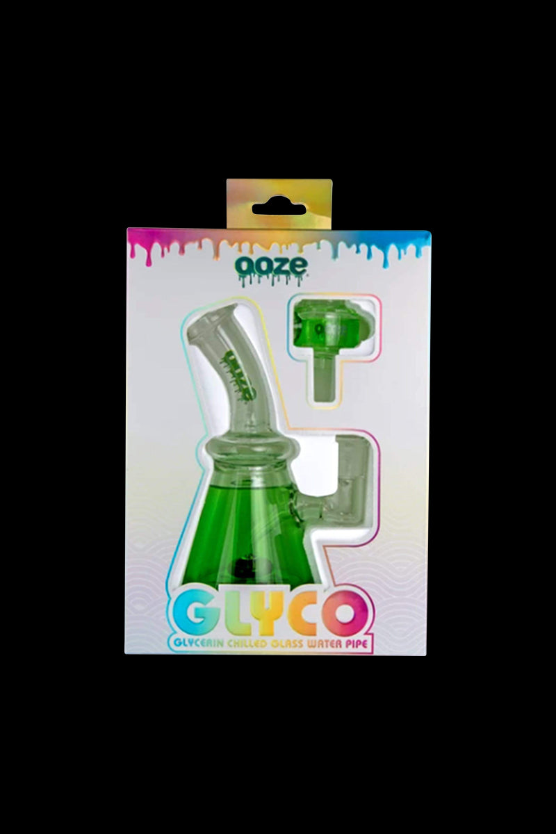 Front-facing boxed view of the Ooze Glyco Glycerin Chilled Bong showing the green glass bong and separate bowl visible through colorful windowed packaging.