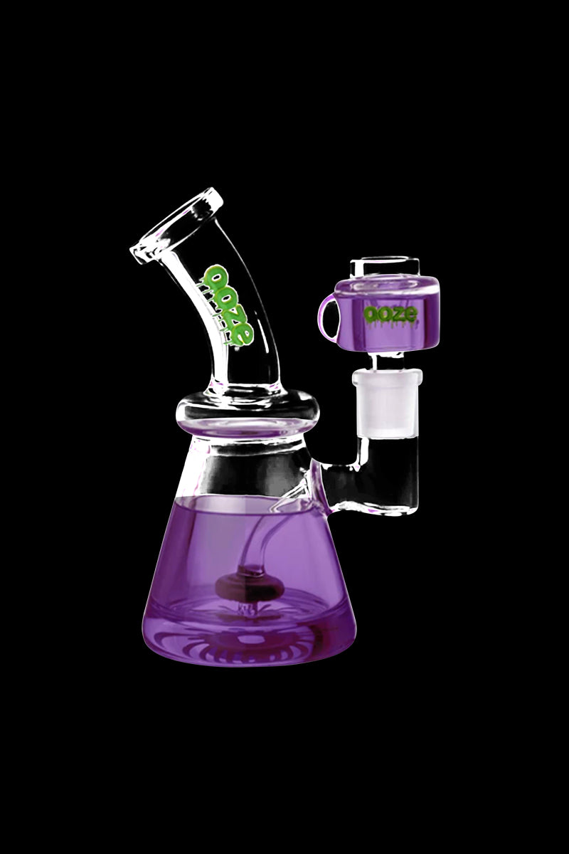 Angled front view of the purple Ooze Glyco Glycerin Chilled Bong against a black background, showing its beaker base and green logo.