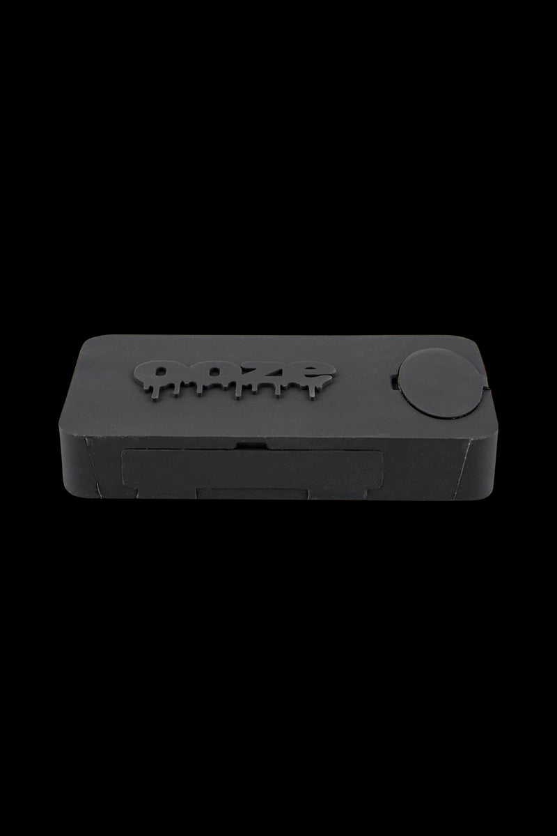 A close-up, angled view of the Ooze Slugger Dabbin Dugout, showcasing its sleek, dark design and compact size.