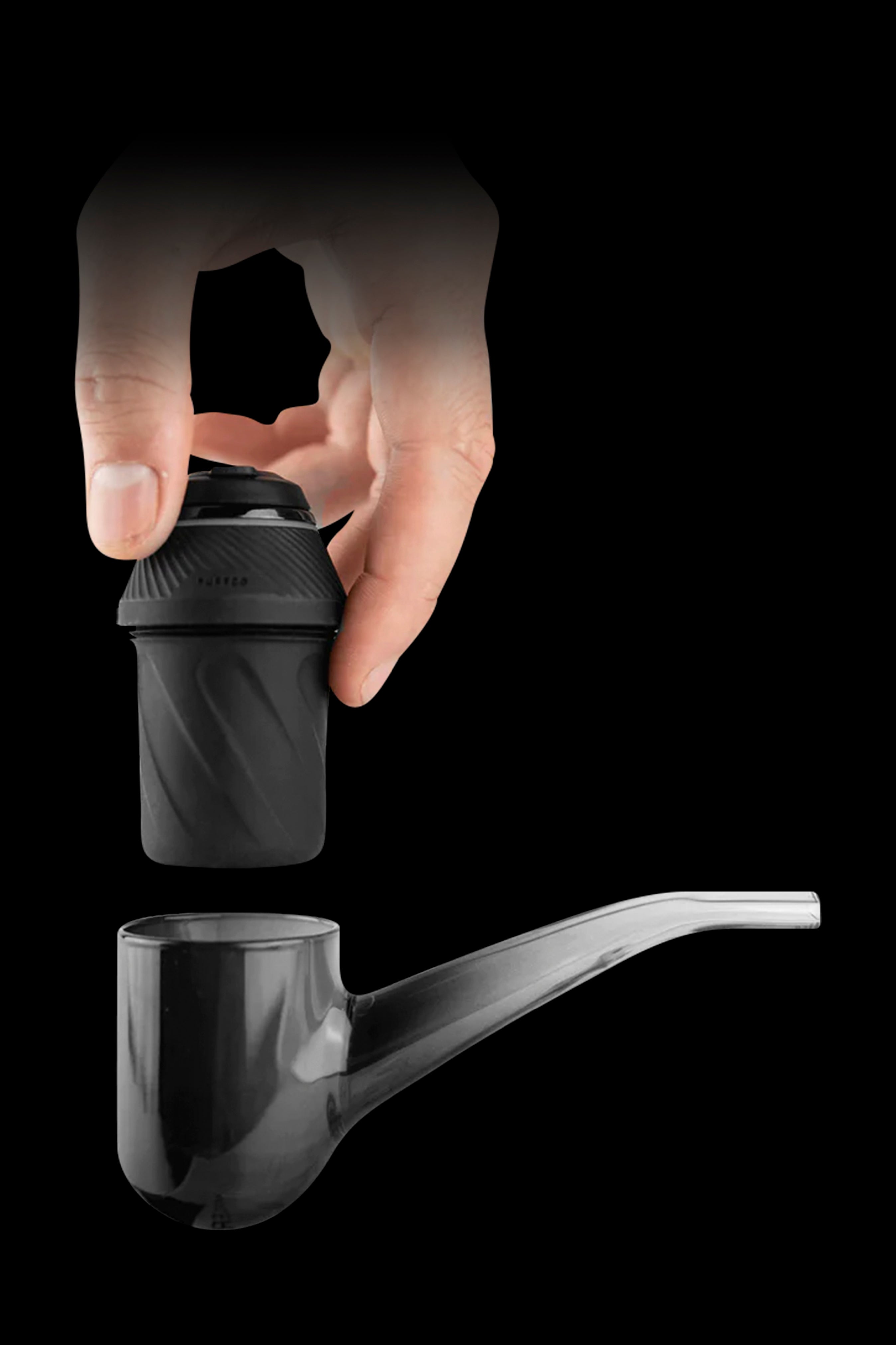Hand holding a black vaporizer component above a glass pipe, product shot.