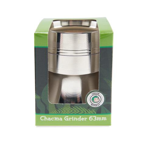 Front-facing shot of a silver Green Monkey Chacma Grinder with Ashtray 63mm visible through its green branded box window on a white background.