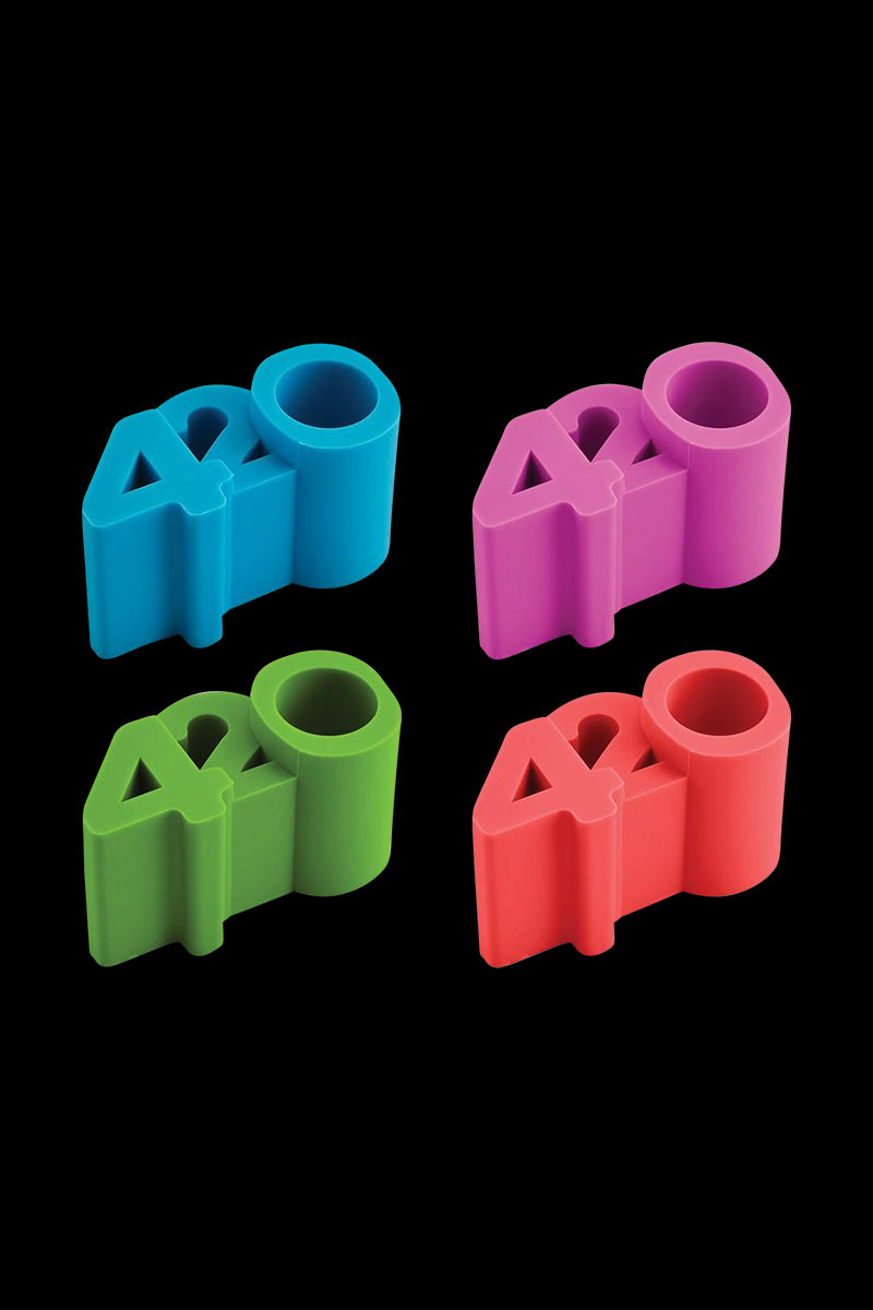 Top-down view of four colorful NoGoo 420 Stand pieces in green, blue, pink, and red arranged in a 2x2 grid on a black background