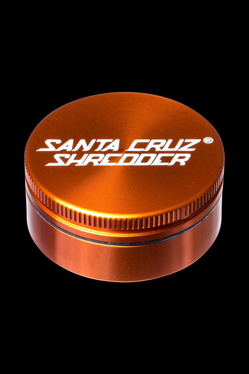 Close-up of the Santa Cruz Shredder Small 2-Piece Grinder, showcasing its metallic, ridged exterior and circular design.
