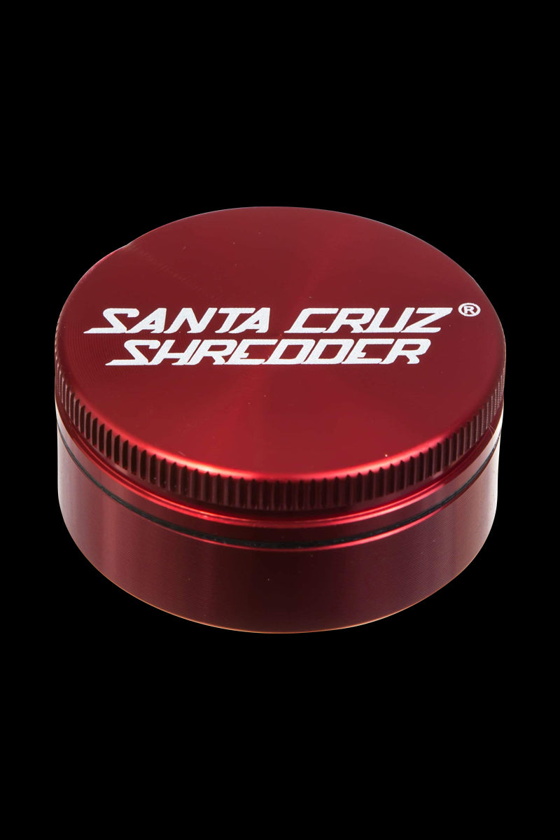 Close-up of the Santa Cruz Shredder Small 2-Piece Grinder, showcasing its metallic, cylindrical shape with textured detailing.