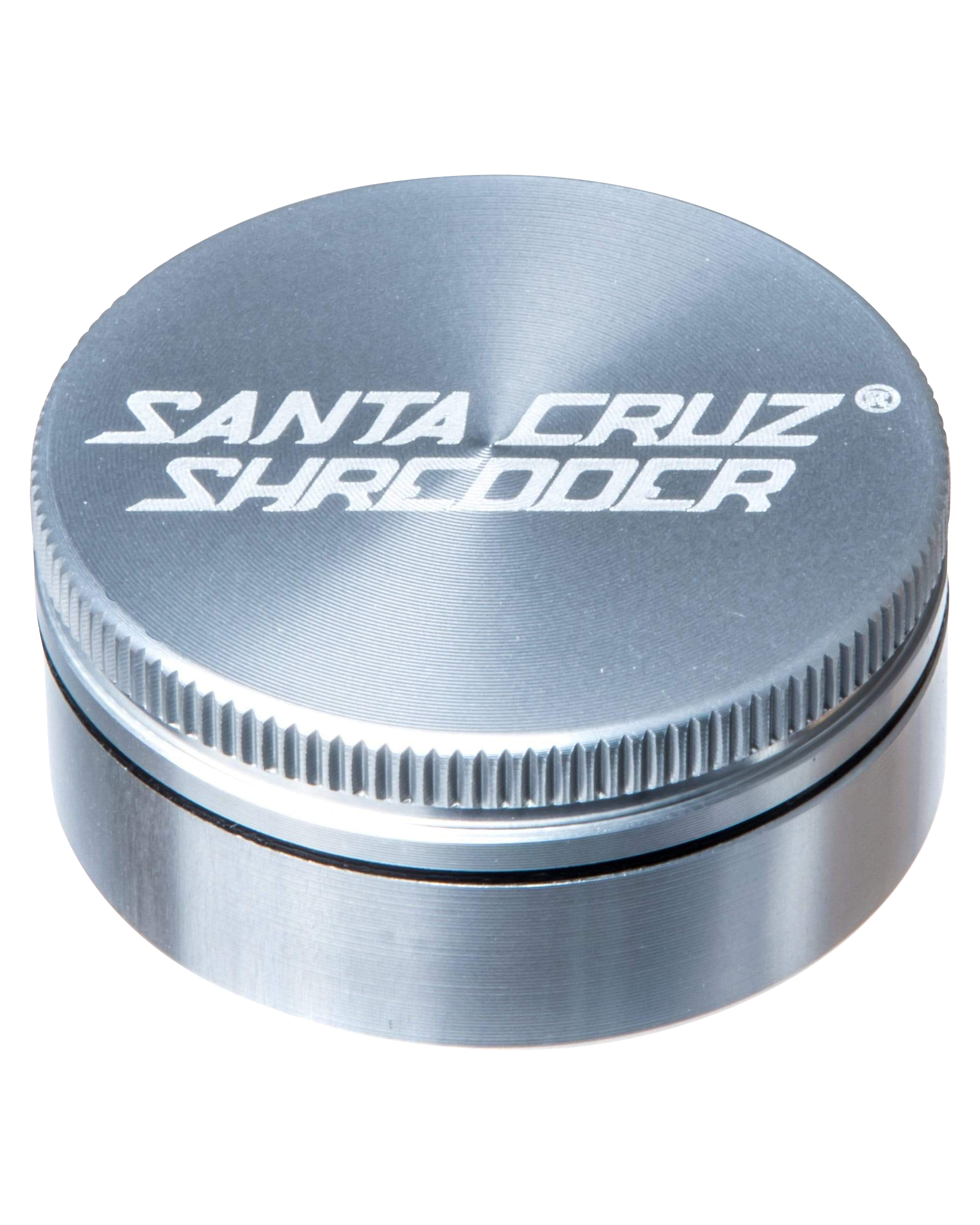 Close-up of the Santa Cruz Shredder Small 2-Piece Grinder, showing its metallic, ridged top against a dark background.