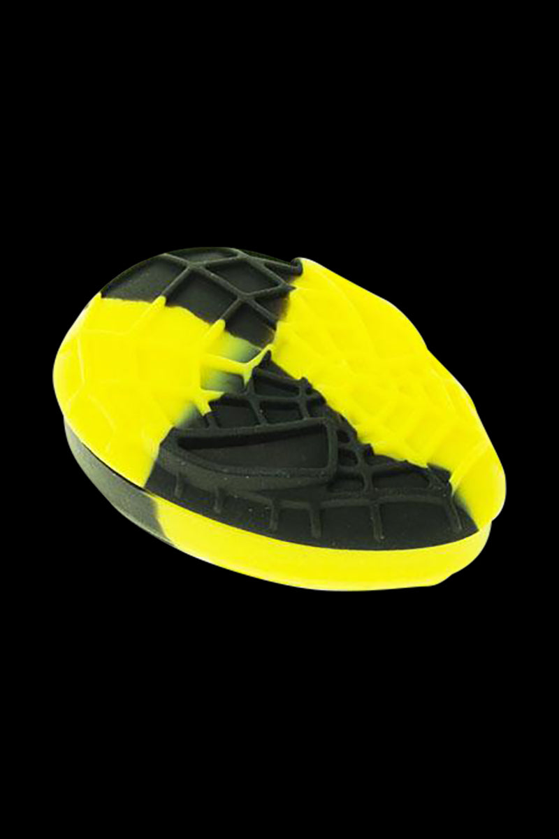 Angled close-up of the Silicone Non-Stick Teardrop Stash Container showing a black-and-yellow teardrop with textured grid patterns against a black background.