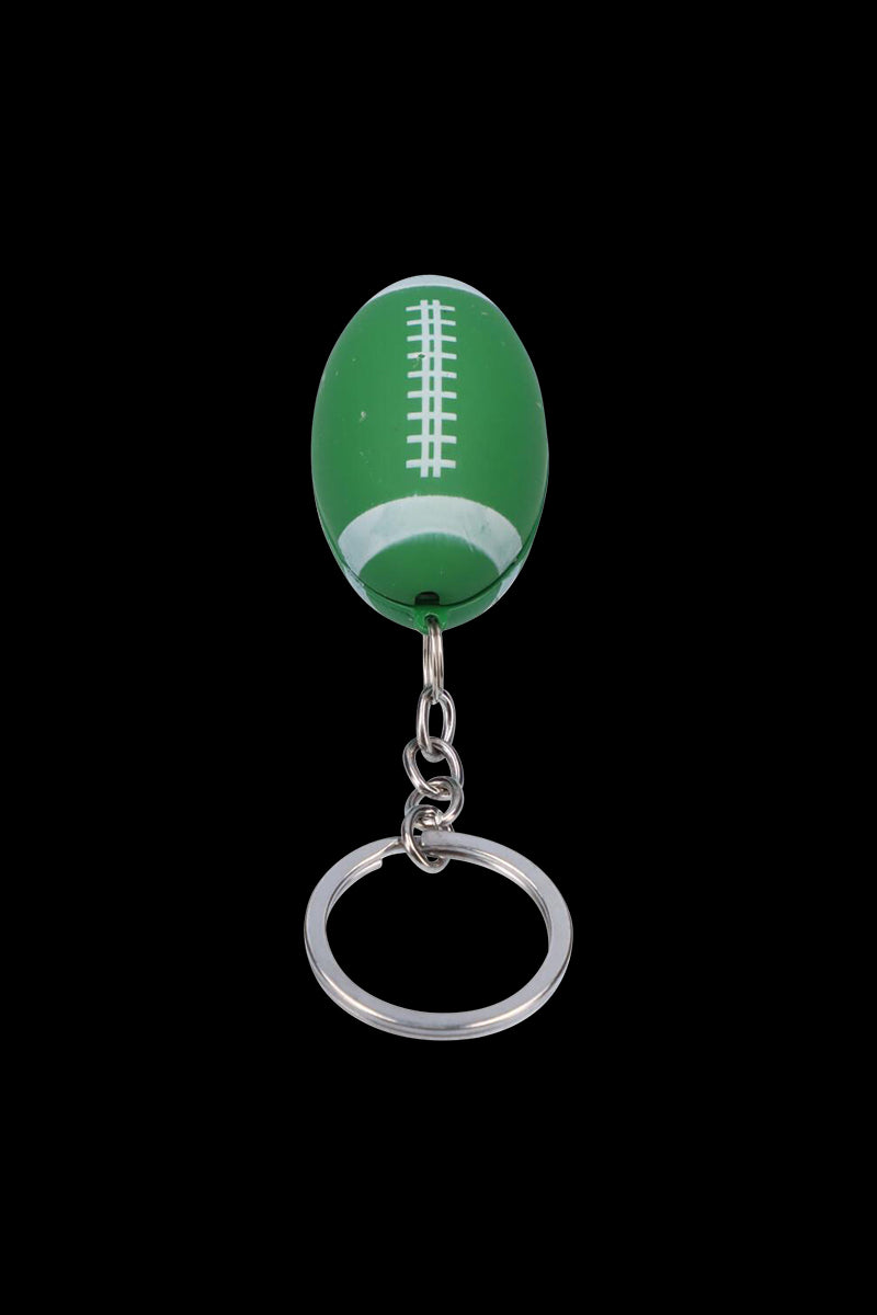 Top-down view of the American Football Metal Hand Pipe with Key Chain showing a green football-shaped pipe attached to a silver key ring against a black background.