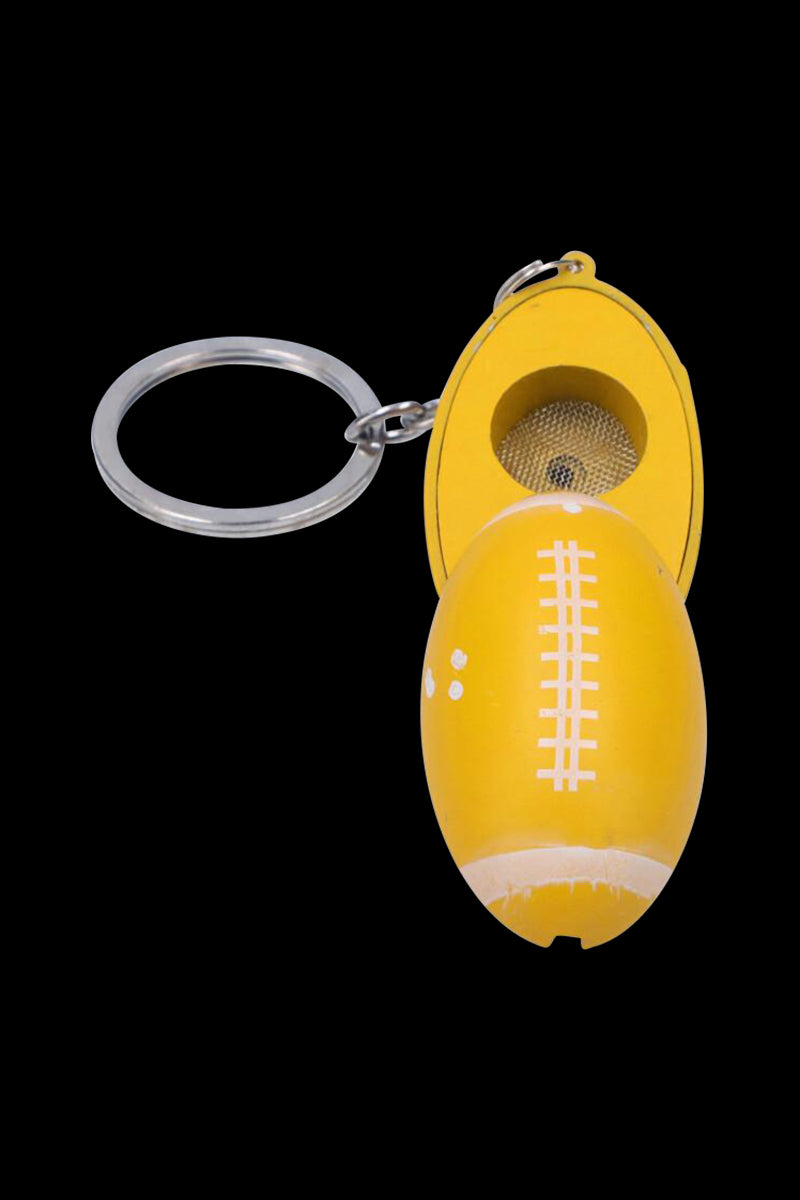Top-down view of the yellow American Football Metal Hand Pipe with Key Chain opened to show its mesh bowl and split shell.