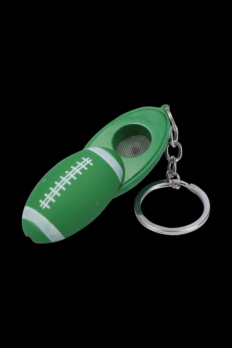 Close-up of the American Football Metal Hand Pipe with Key Chain in bright green, shown open to reveal its metal screen and ring.