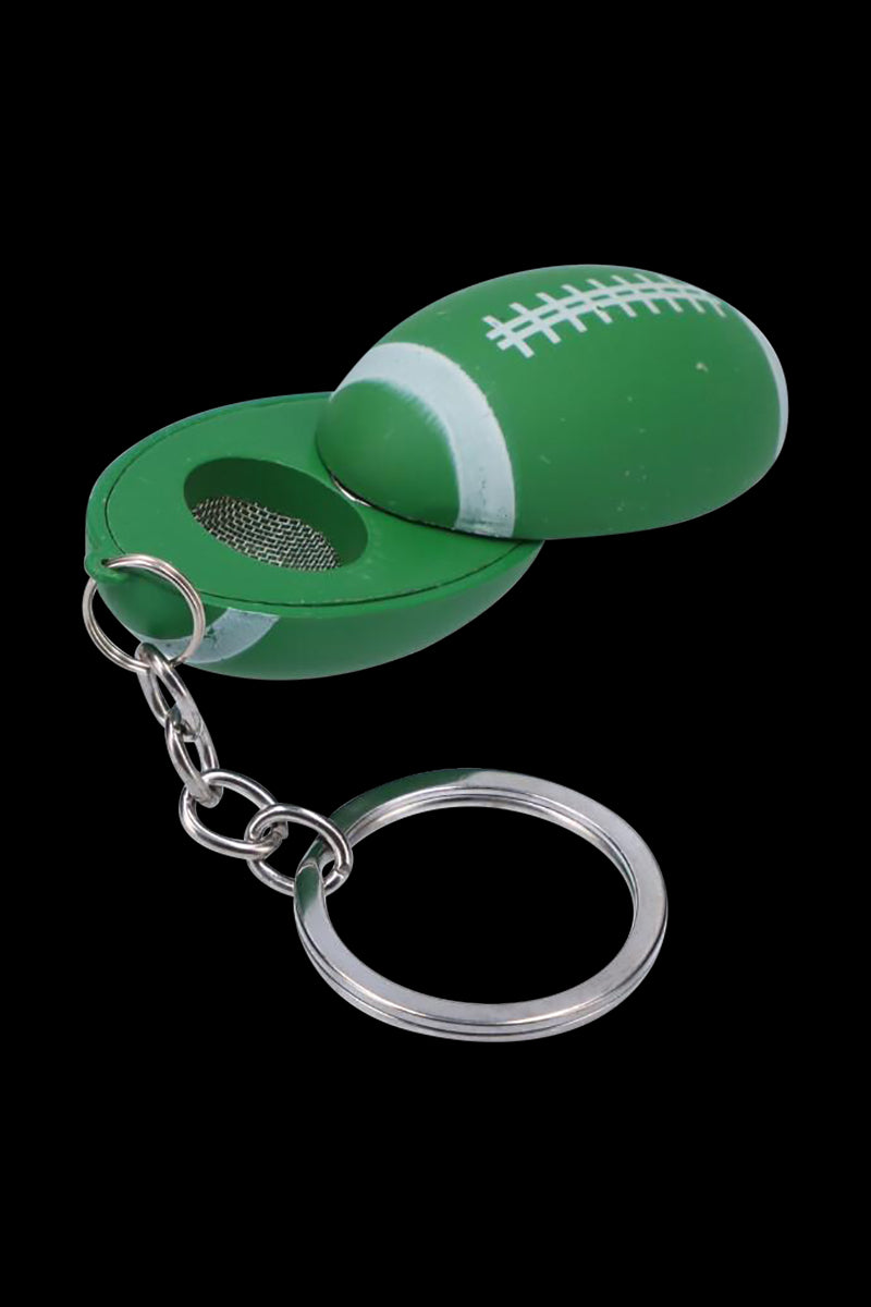 Top-down close-up of the American Football Metal Hand Pipe with Key Chain opened to show its green football shell, mesh bowl, and silver key ring.