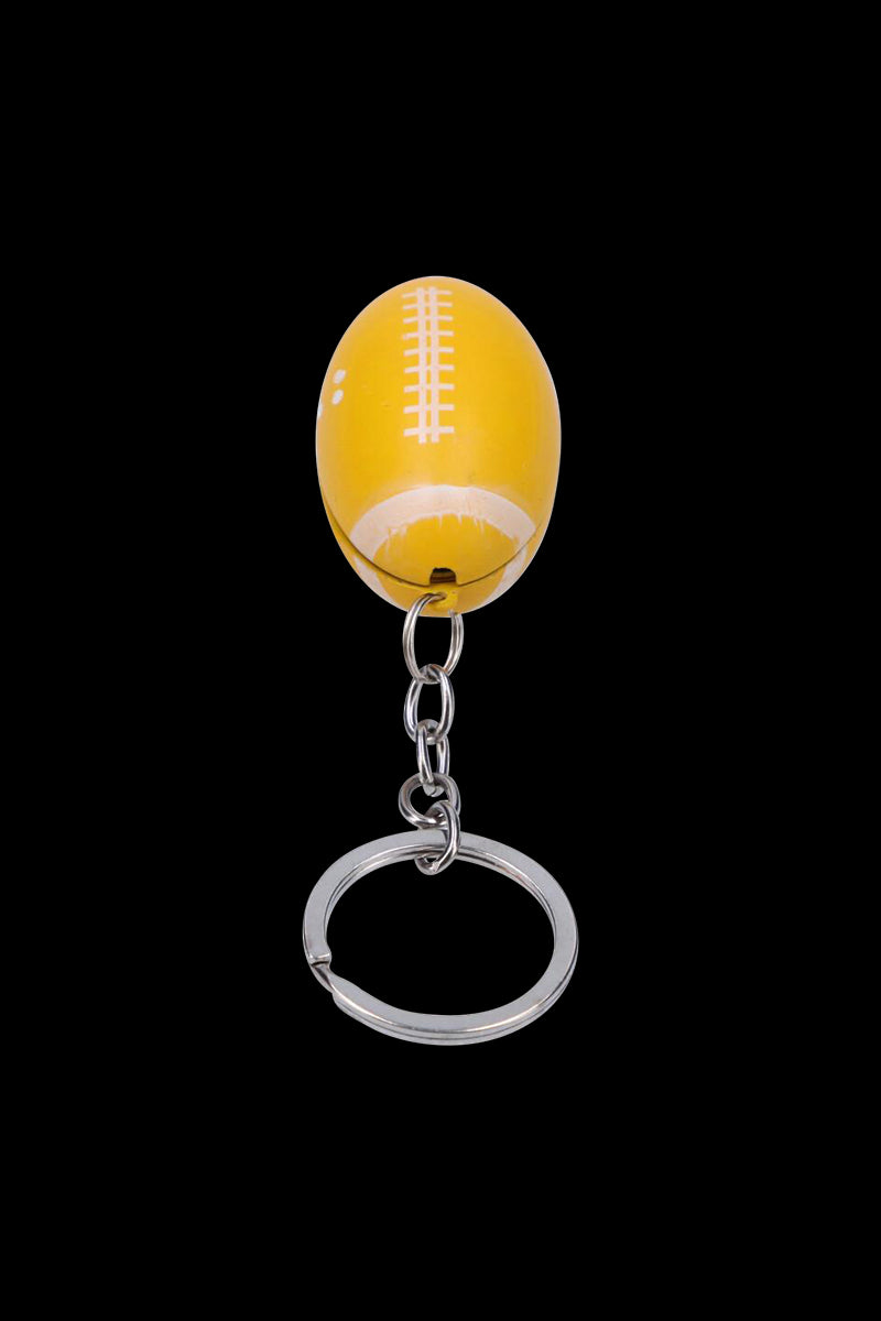 Top-down view of the American Football Metal Hand Pipe with Key Chain showing a yellow football-shaped pipe attached to a short silver chain and split ring on a black background.