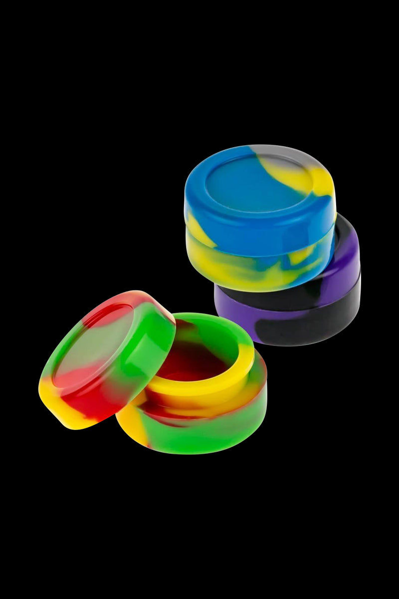 A slightly angled view of the Silicone Non-Stick Stash Container, showcasing a stack of colorful, small containers against a dark background.