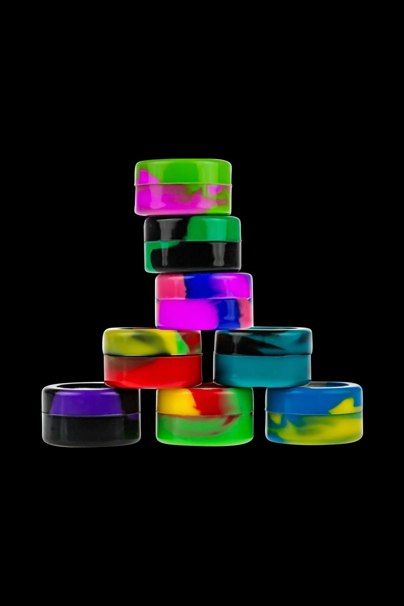A top-down view of multiple Silicone Non-Stick Stash Containers, stacked and showcasing their colorful, translucent designs.