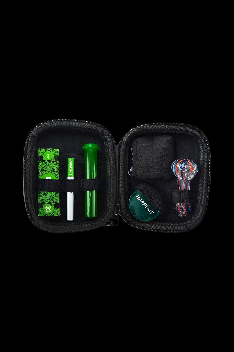 Open black case displaying cannabis accessories including a glass pipe, grinder, and container with the “HappyKit” logo.