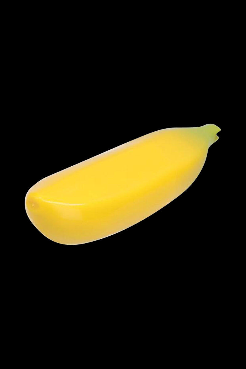 Angled studio shot of the Metal Hand Pipe with Silicone Banana Skin against a black background, showing its glossy yellow banana shape.