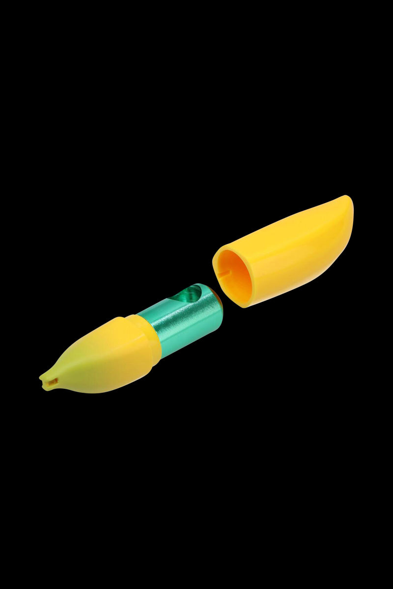 Angled close-up of the Metal Hand Pipe with Silicone Banana Skin showing its green metal body and two yellow banana-shaped silicone halves against a black background