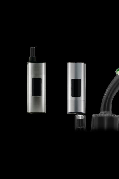 Silver cannabis vaporizer pens and dab rig attachment on a black background.