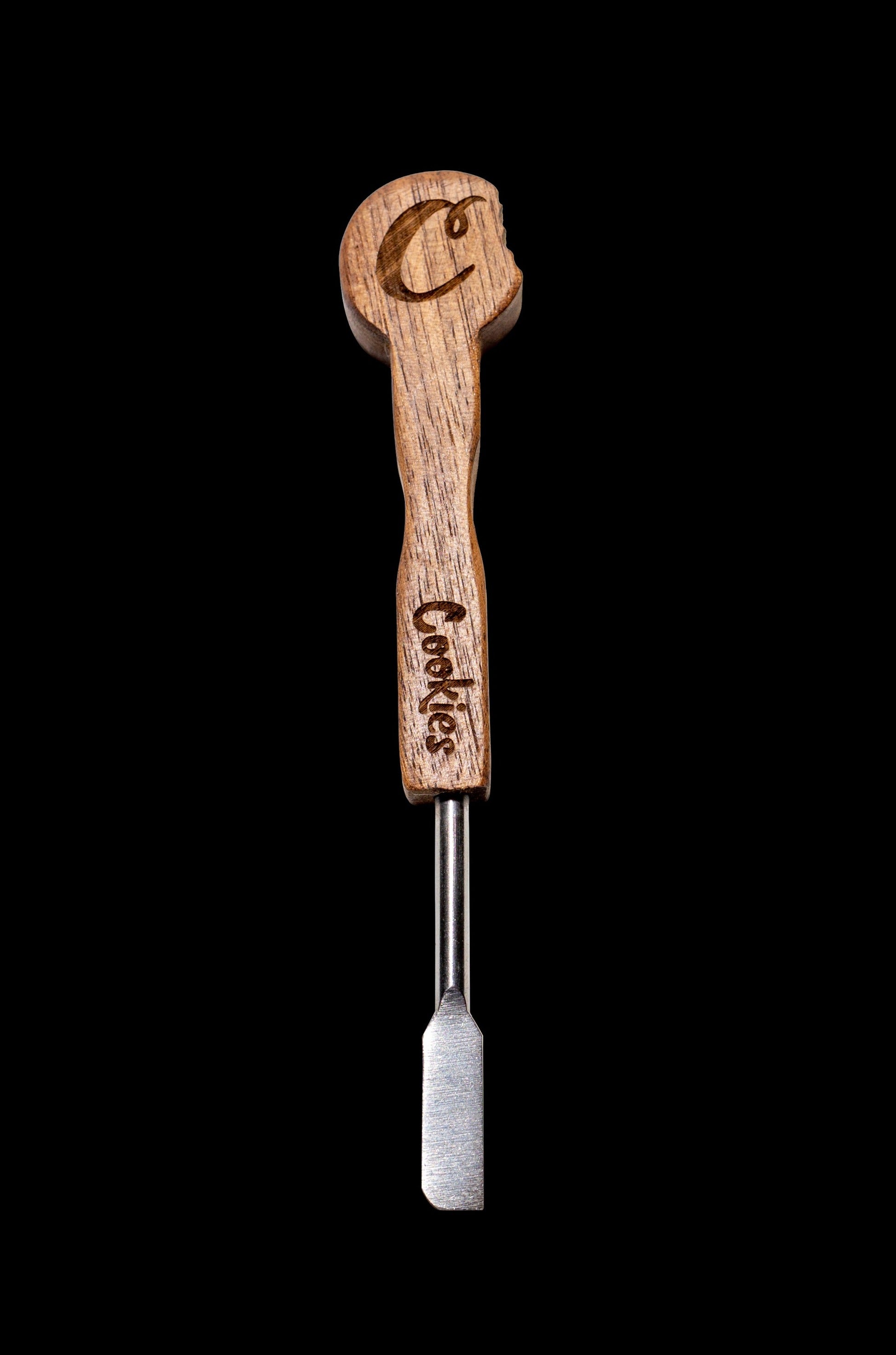 Wooden and metal dab tool with "Cookies" branding against a black background.