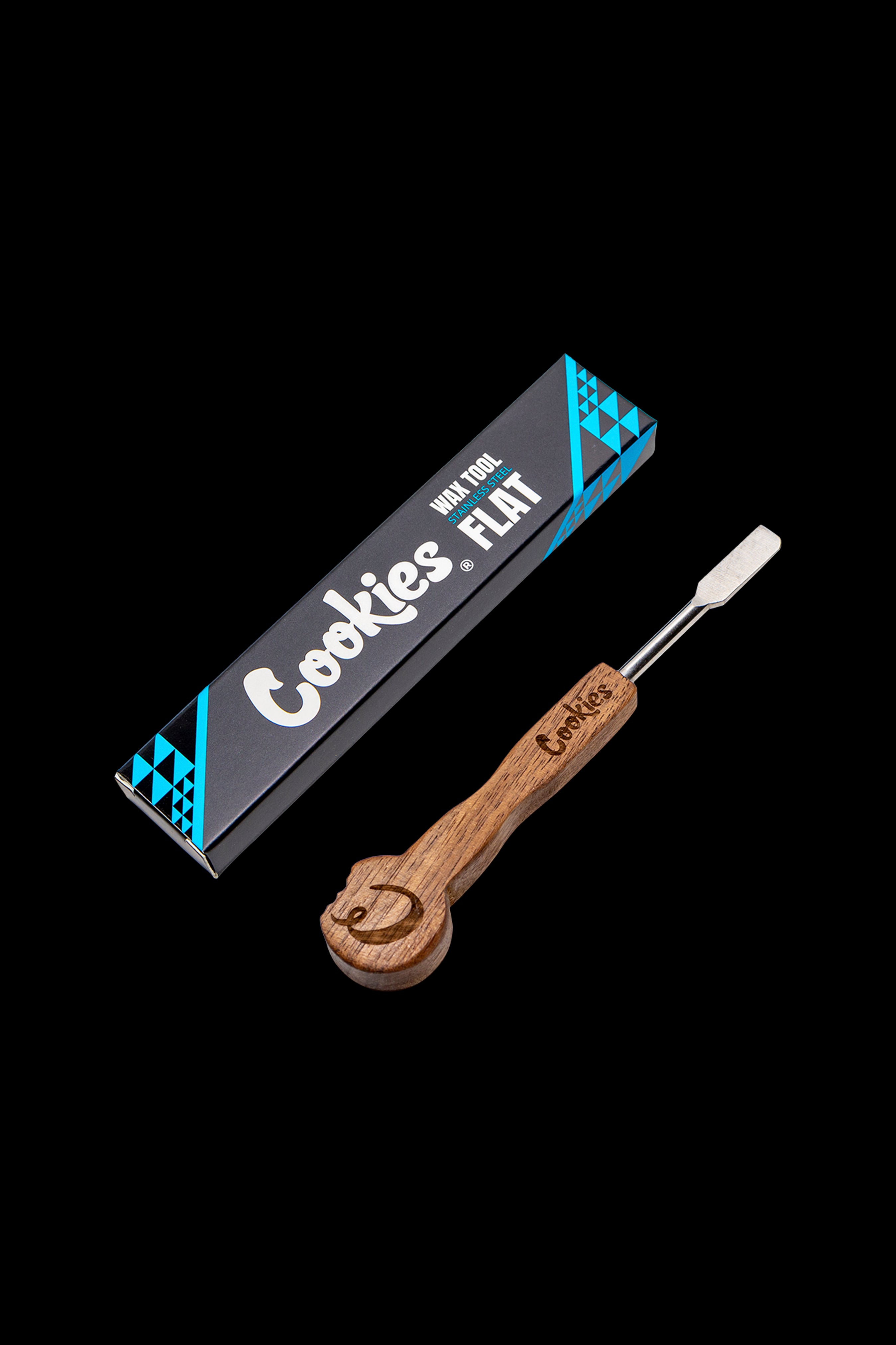 Cookies brand wax tool with wooden handle and flat metal tip, displayed with its packaging.