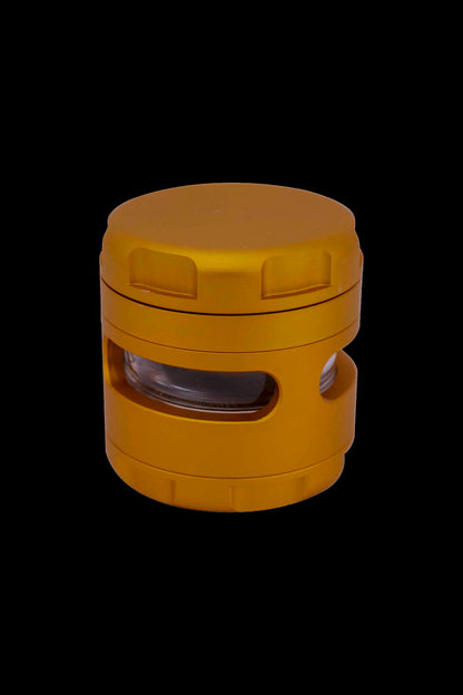Orange cannabis grinder with viewing window.