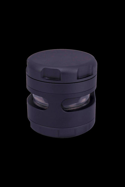 Dark purple cannabis grinder with visible grinding teeth and chambers.