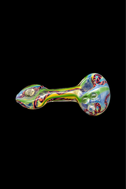 Colorful glass pipe with bubble detailing, isolated on a black background.