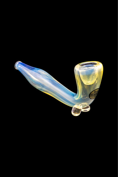Iridescent glass bubbler pipe for smoking, isolated on a black background.