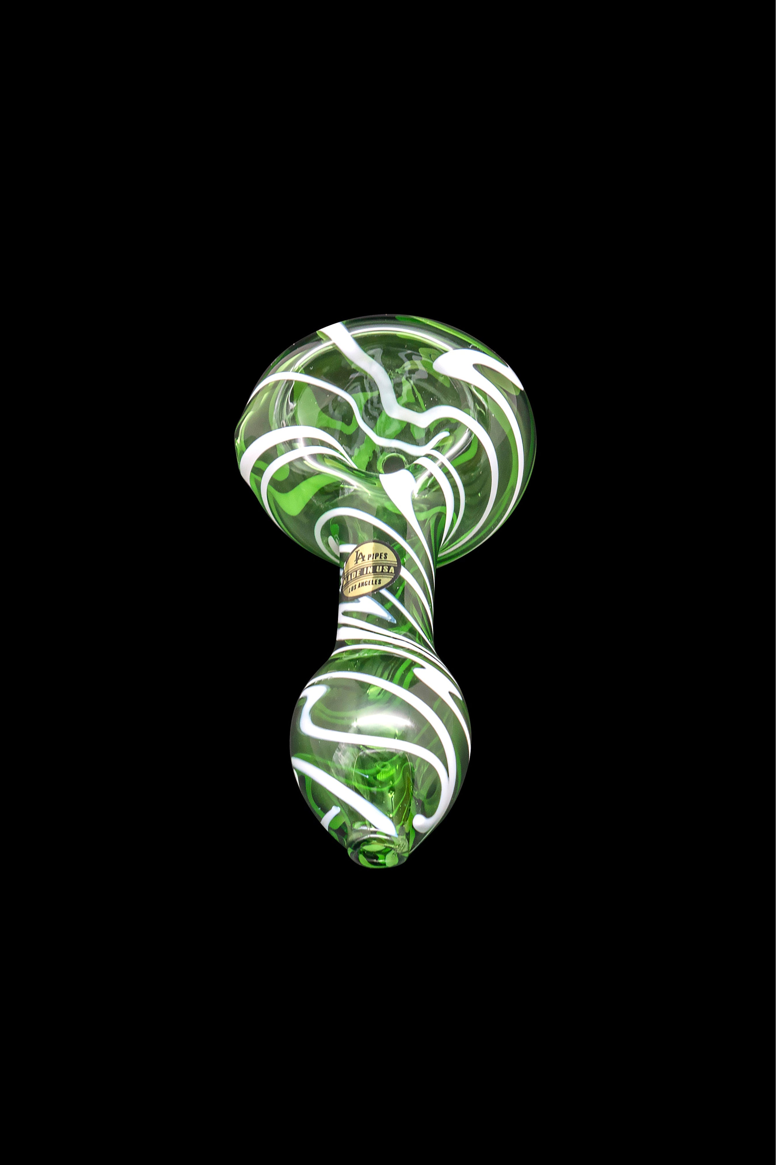 Green and white glass cannabis pipe isolated on a black background.