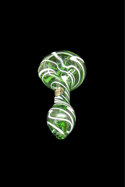 Green and white glass cannabis pipe isolated on a black background.