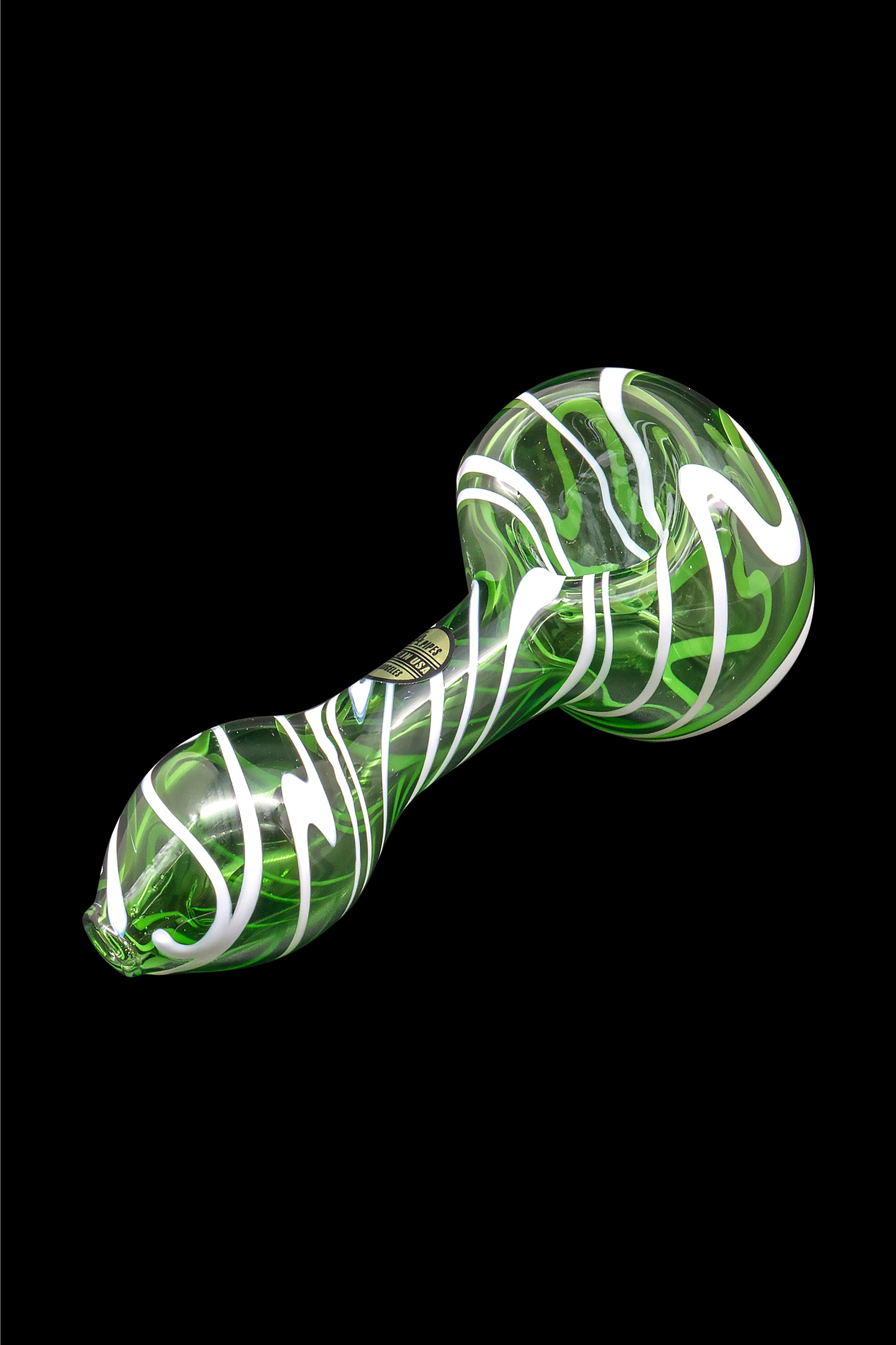 Green and white swirled glass spoon pipe against a black background.