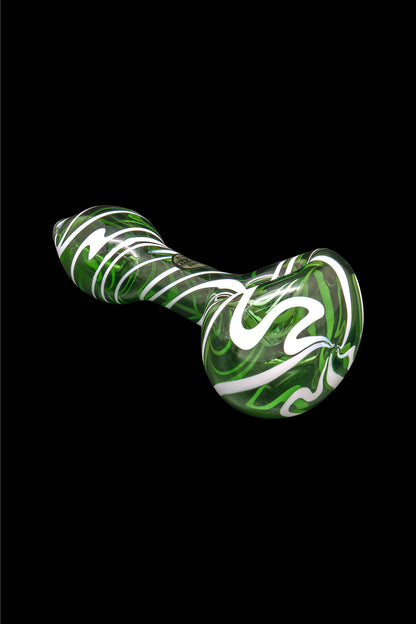 Green and white swirled glass smoking pipe on a black background.