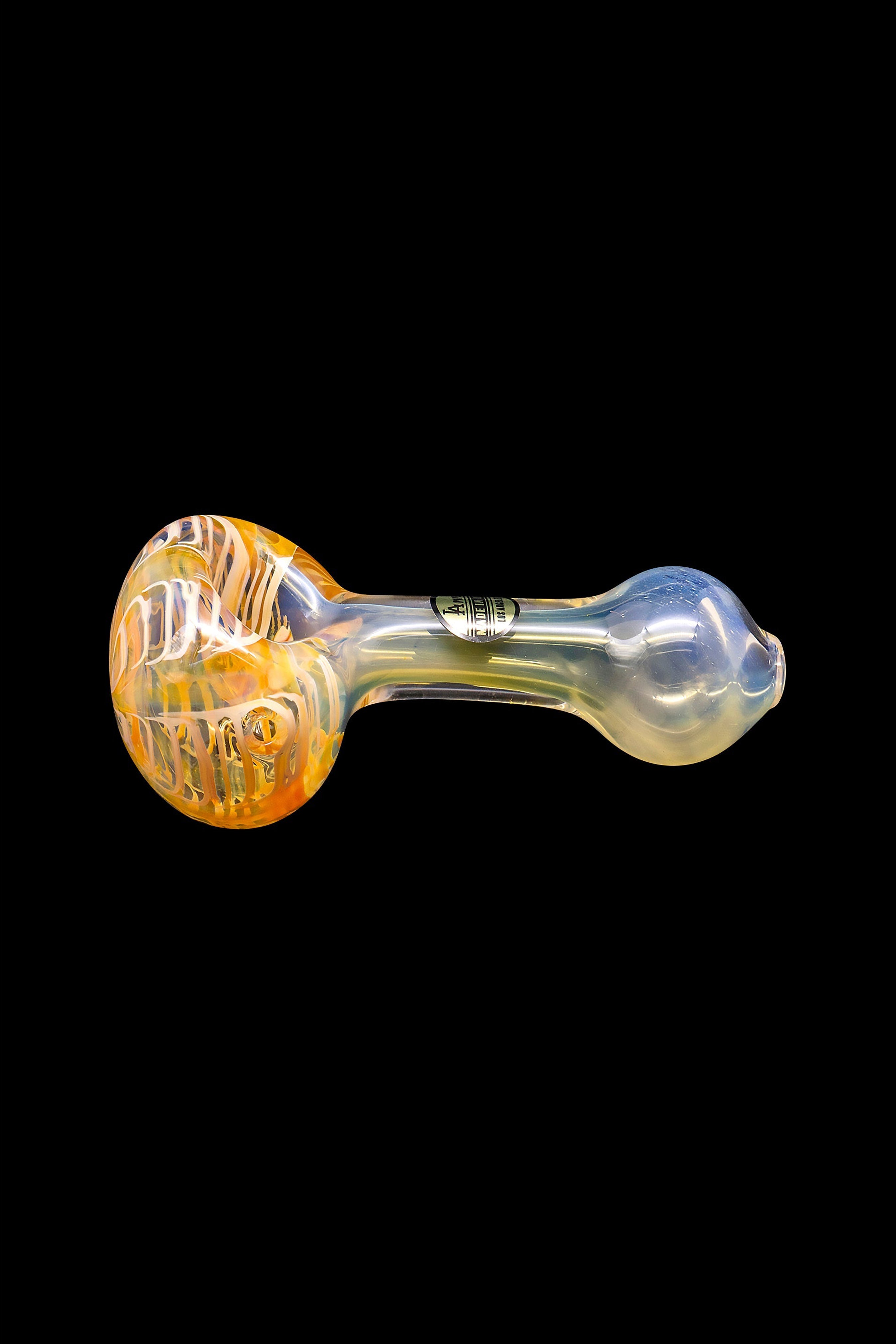 Glass cannabis pipe with orange and yellow swirls against a black background.