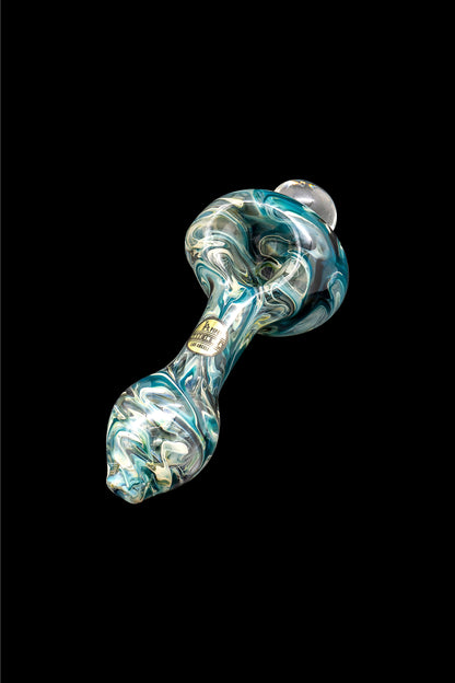 Hand-blown glass pipe with teal and gold swirls, isolated on a black background.