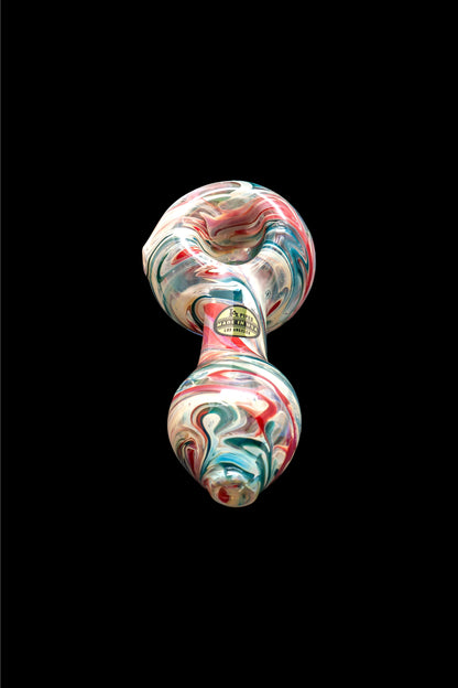 A vibrant glass pipe with a swirling red, white, and blue pattern, against a black background.