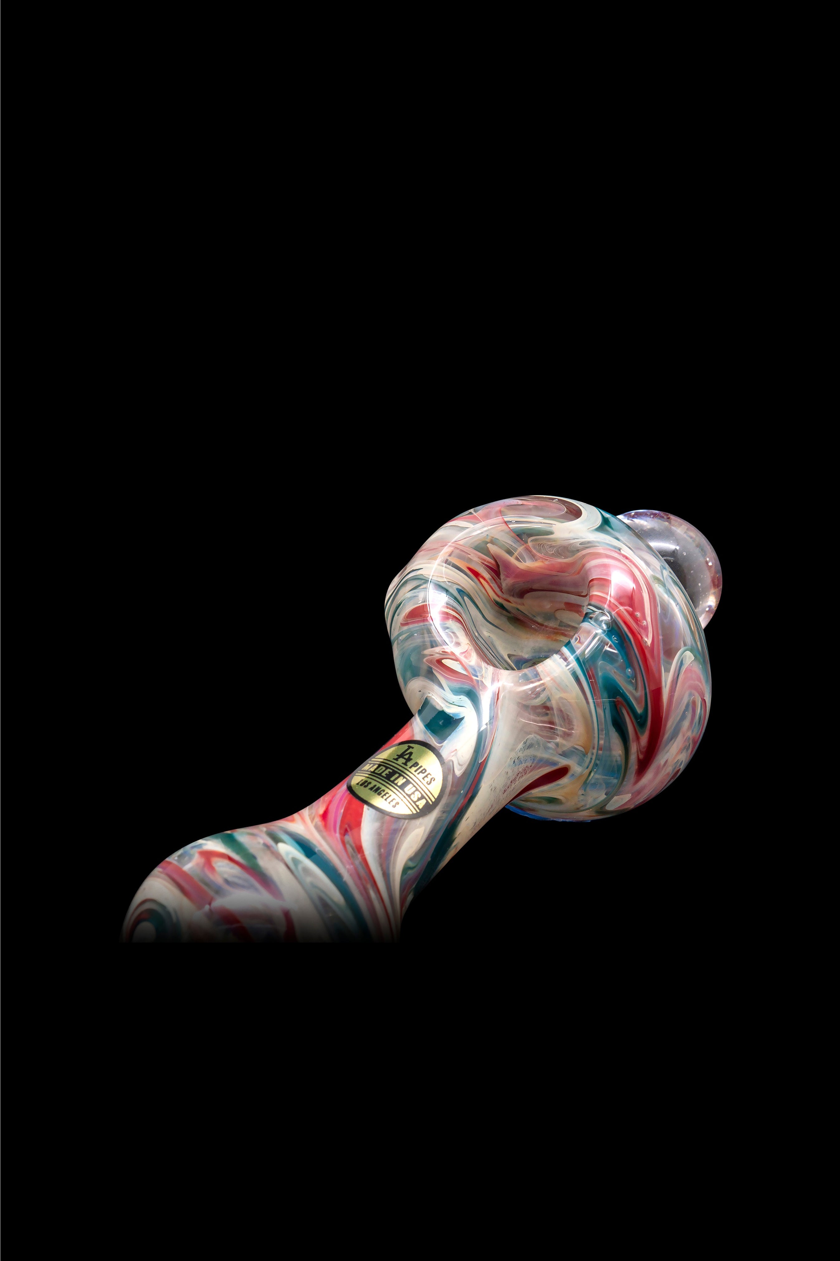 Hand-blown glass pipe with vibrant red, blue, and white swirls against a black background."
