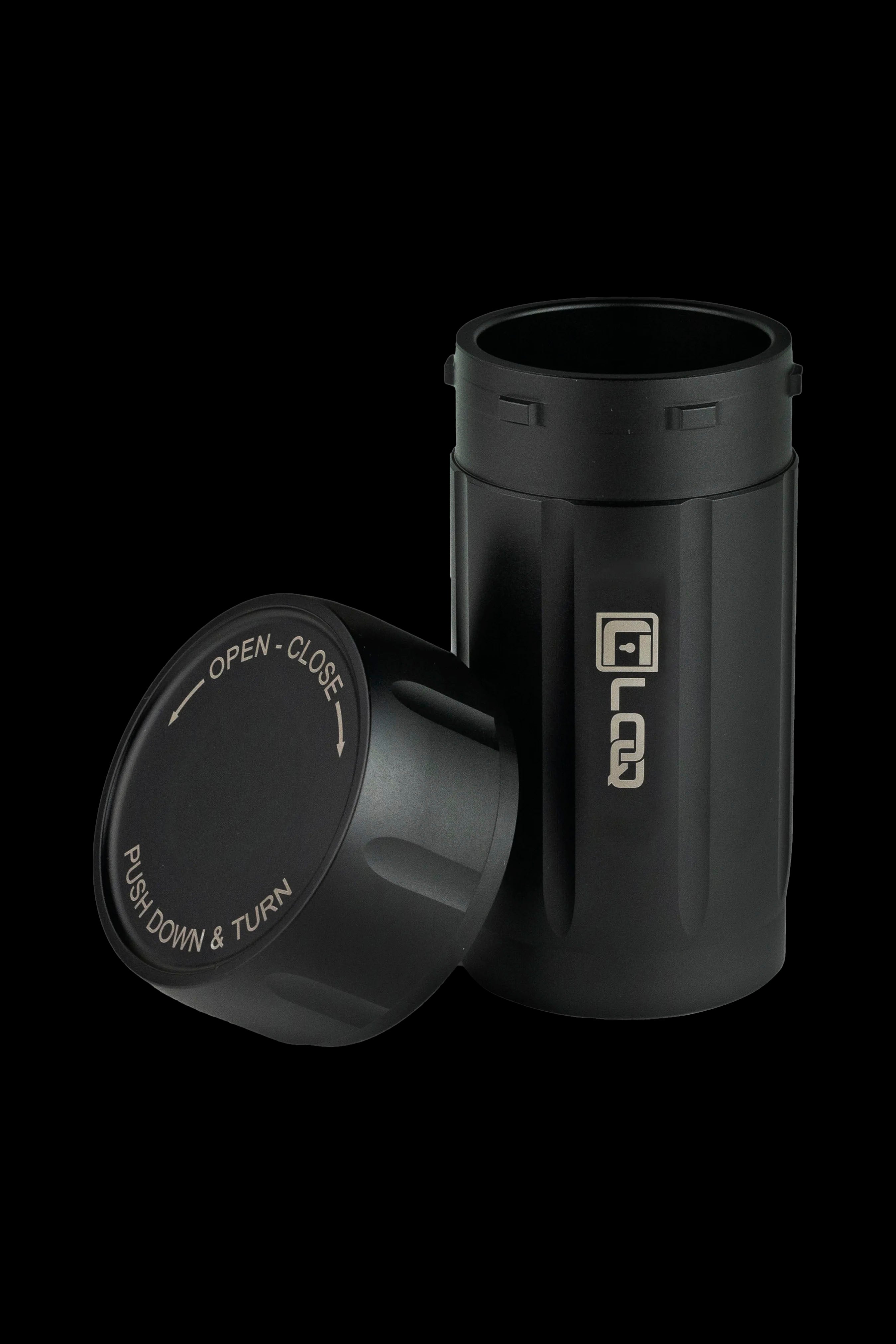 Black cannabis storage container with a twist-top lid displaying opening/closing instructions.