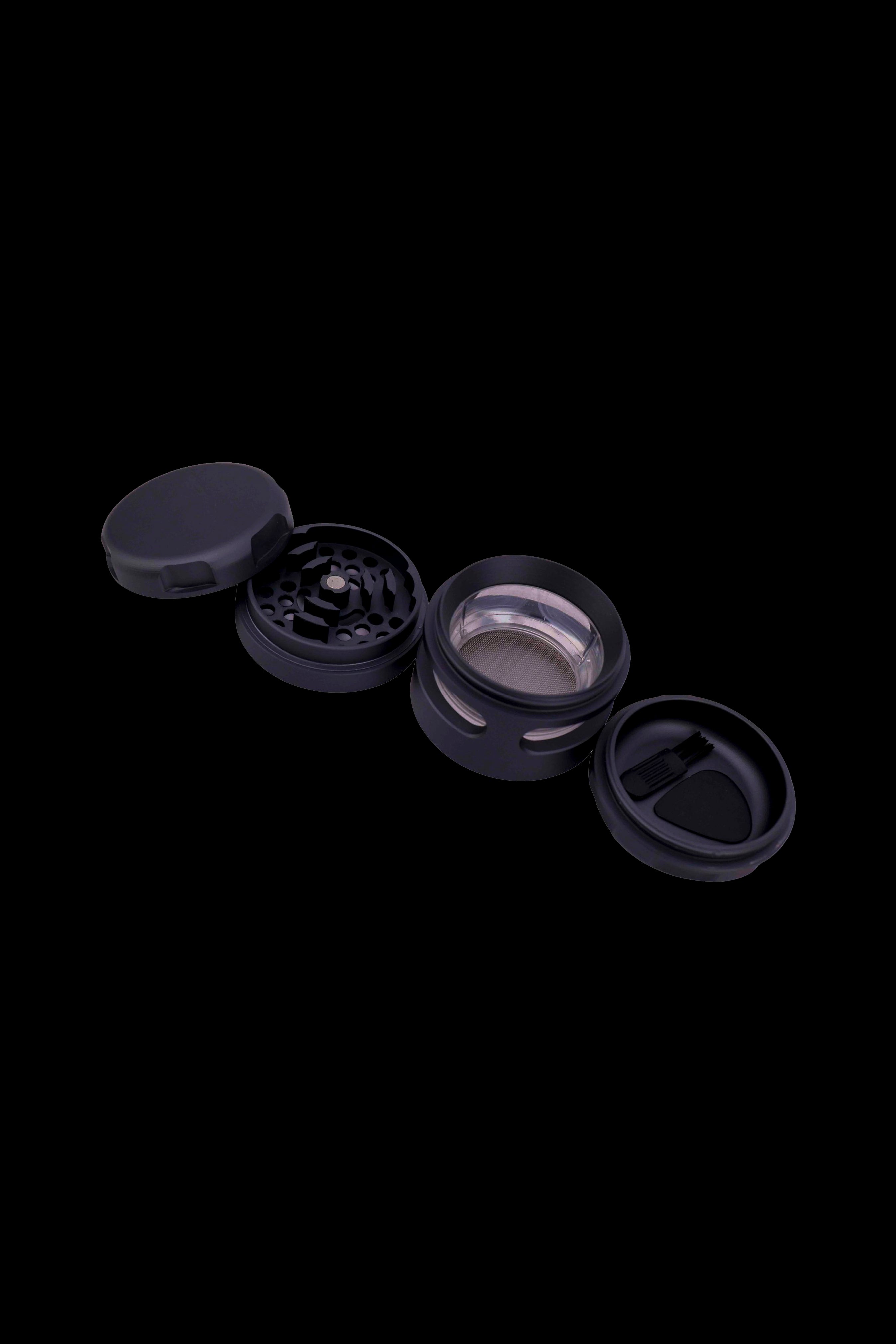Black four-piece cannabis grinder disassembled on a black background.